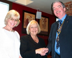 Jane Butler is welcomed as a Rotarian by Peter Gallivan and her proposer Sue Parkin 1